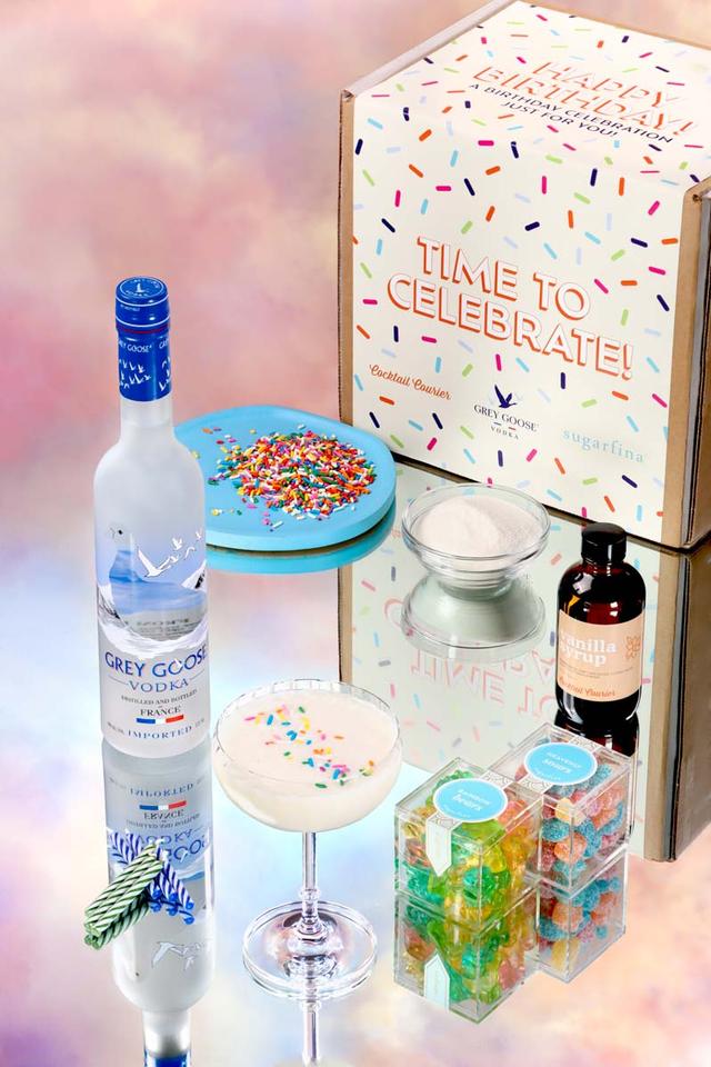 Birthday Cake Cocktail with bottle of Grey Goose Vodka and Gummy Bears With Dreamy Background.